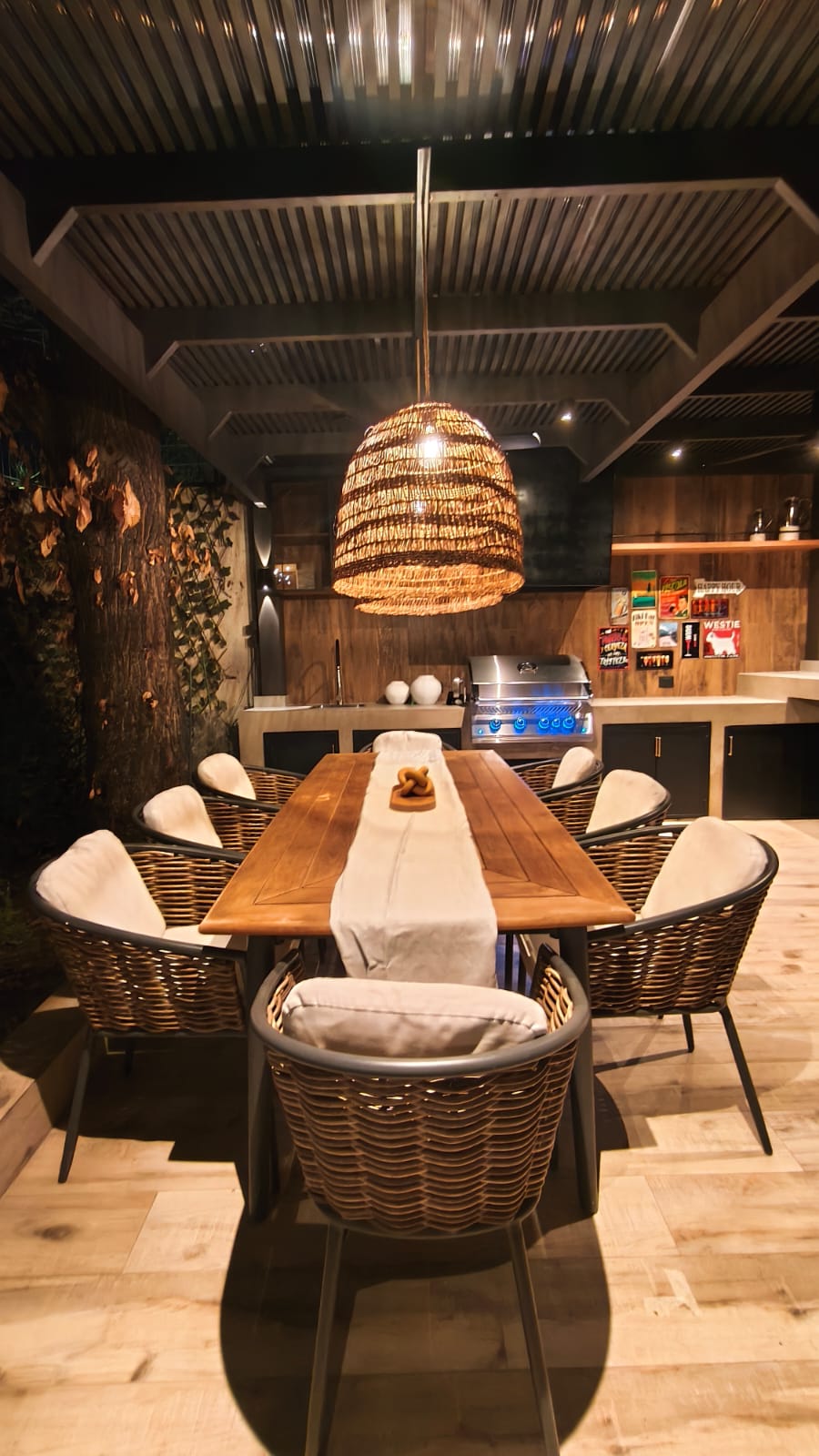Quincho residencial con comedor y mobiliario junto a la parrilla